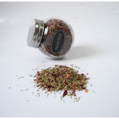 mixing seasoning and spices thyme chili flakes in customized spice bottle