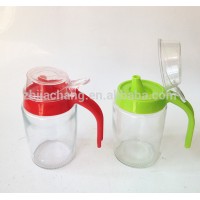 handling glass cooking oil dispenser jar with plastic spout and lid